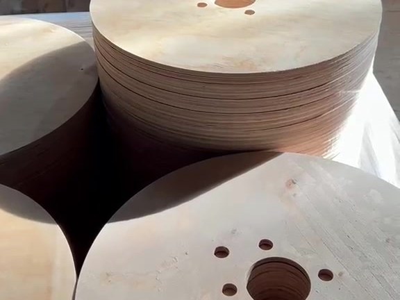 Finished plywood cable drum flanges stacked after machining