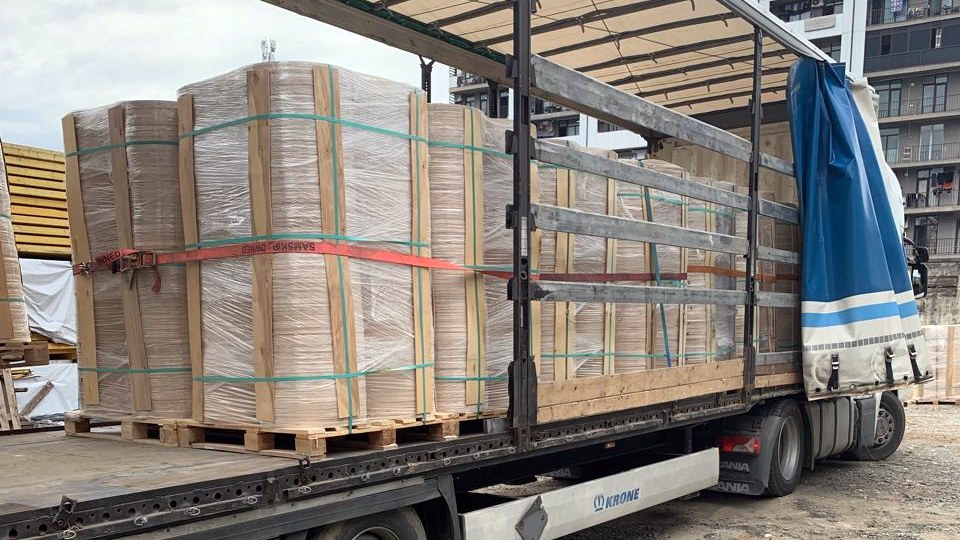 Palletized plywood components loaded for international road transport